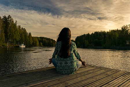 woman in green and white long-sleeved top sitting thumbnail