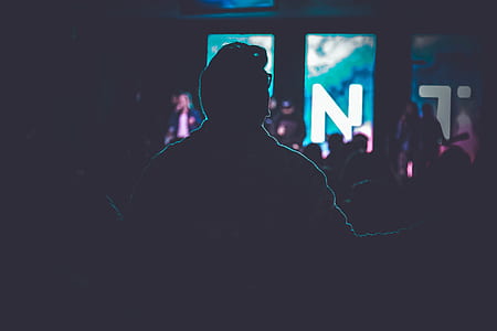 silhouette of person near lights in dark room thumbnail