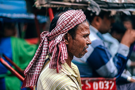 man wearing gingham headdress near man inside vehicle during day thumbnail