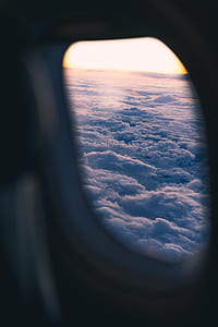 white clouds outside airplane window thumbnail