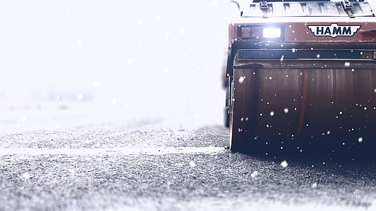 red Hamm road roller on gray road thumbnail