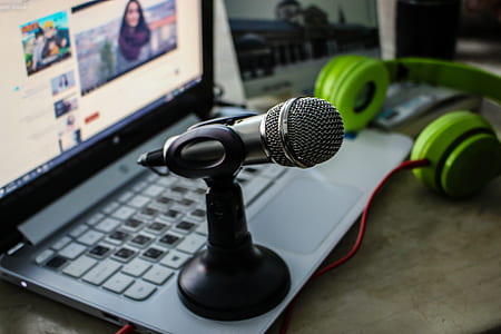 Green Headphones Near Laptop and Microphone thumbnail