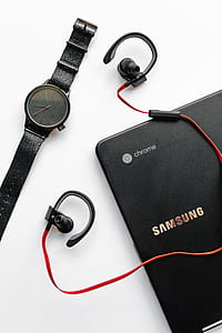 round gray analog watch with black strap beside black Samsung Chromebook thumbnail