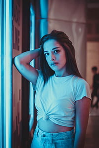 woman standing beside neon signage thumbnail
