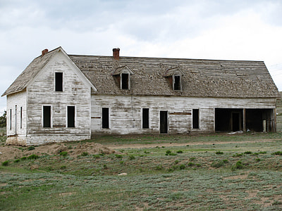 white wooden house in green field thumbnail