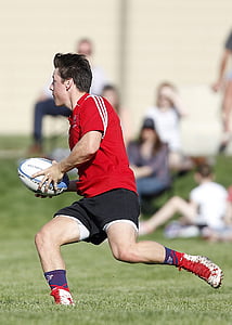 man holding football during daytime thumbnail