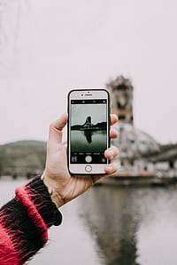 person capturing photo of brown building thumbnail