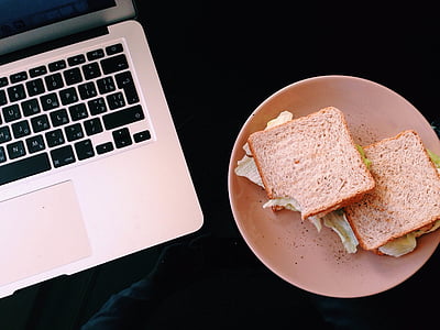 sandwiches on plate beside laptop thumbnail
