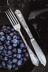 Fresh blueberries on a black plate with vintage cutlery thumbnail