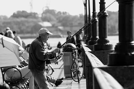 grayscale photography of man fishing thumbnail
