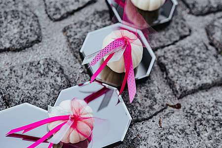 Decorative white pumpkin trinkets with ribbons on the floor thumbnail