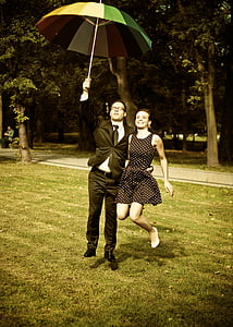 man holding umbrella and embracing the woman thumbnail