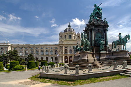 brown concrete building with statue during daytime thumbnail