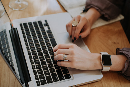 person in silver ring holds a MacBook Pro thumbnail