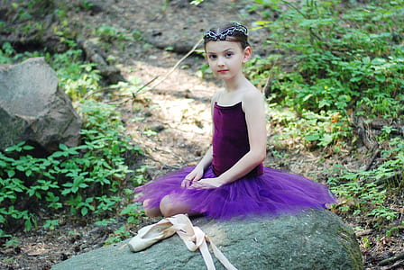 girl in purple tutu dress sitting during daytime thumbnail