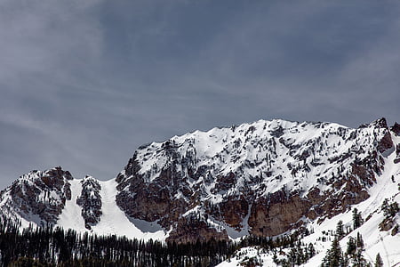 snow covered mountain under gray sky at daytime thumbnail