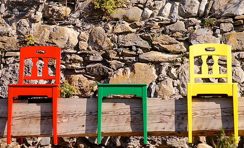 red, green, and yellow wooden chairs thumbnail