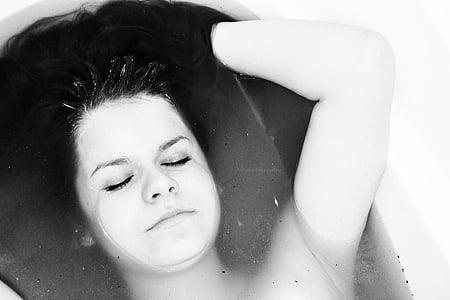 grayscale photo of woman in bathtub thumbnail