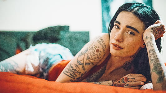 woman lying on orange cushion thumbnail