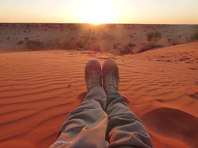 person pair of white shoes sitting on the sand thumbnail