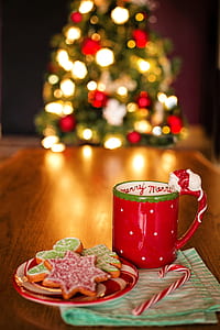 red ceramic mug beside cookies on saucer thumbnail