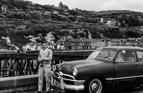 man standing on black car thumbnail