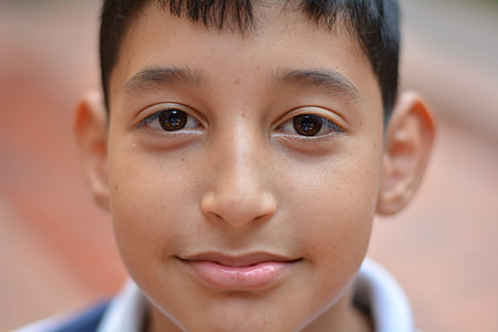 selective focus photography of boy's face thumbnail