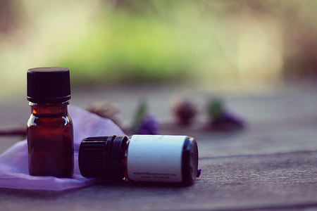 two brown glass vials on brown wooden surface thumbnail
