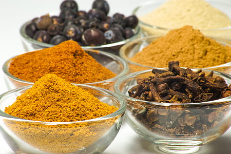closeup of six assorted spices in clear glass bowls thumbnail
