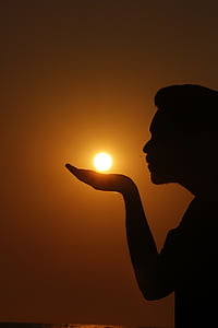 silhouette of a person as if he/she is summoning the sun on his/her hand thumbnail