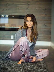 woman sitting on rug beside wall thumbnail
