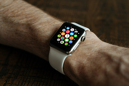 person wearing silver aluminum case Apple Watch with white sport band thumbnail