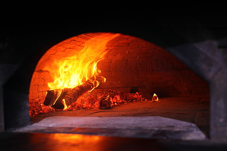 wood burned with flame inside brick oven thumbnail