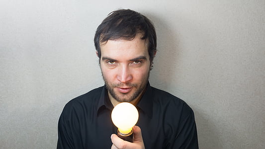 man holding lighted lightbulb thumbnail