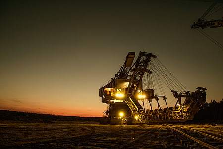 black and yellow industrial heavy equipment during sunset thumbnail