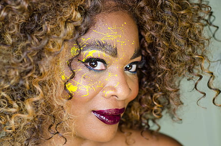 smiling woman with yellow paint thumbnail