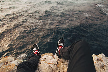 man sitting on cliff thumbnail