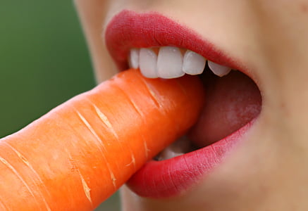 woman with red lipstick bites carrot thumbnail