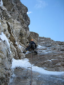 person climbing on rock during daytime thumbnail