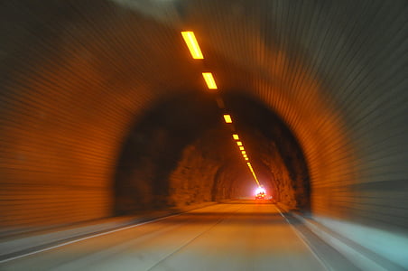 panning photography of vehicle travelling in tunnel with light thumbnail