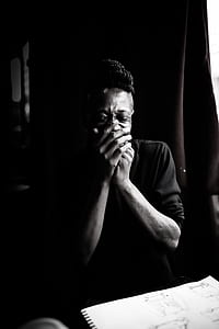 grayscale photo of man laughing in front of paper thumbnail