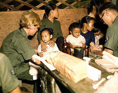 Nurse treats a Vietnamese child, 1967 during the Vietnam War thumbnail