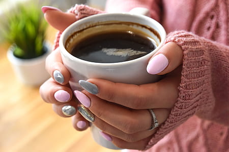 person holding white mug thumbnail
