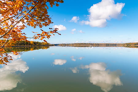 mountain across body of water under blue sky thumbnail
