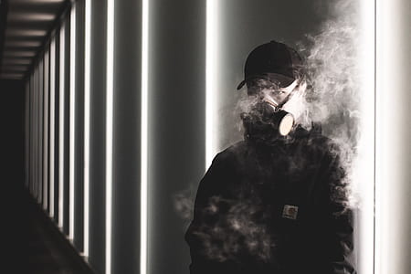 man wearing gas mask in grascale photo thumbnail