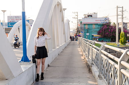woman standing on white bridge thumbnail