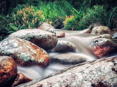 Time Lapse Photo of River Flowing on Rocks thumbnail