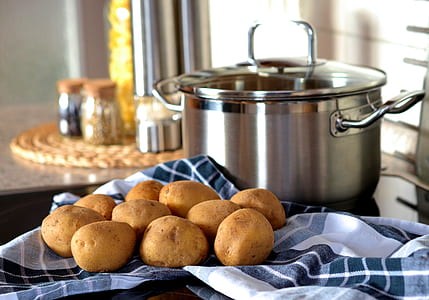 stainless steel cooking pot near potatoes thumbnail