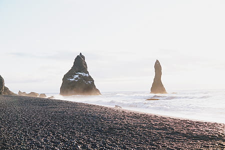rock formation by the ocean during daytime thumbnail