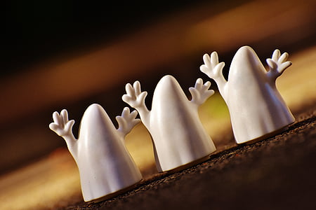 shallow focus photo of three white ghost figurines thumbnail